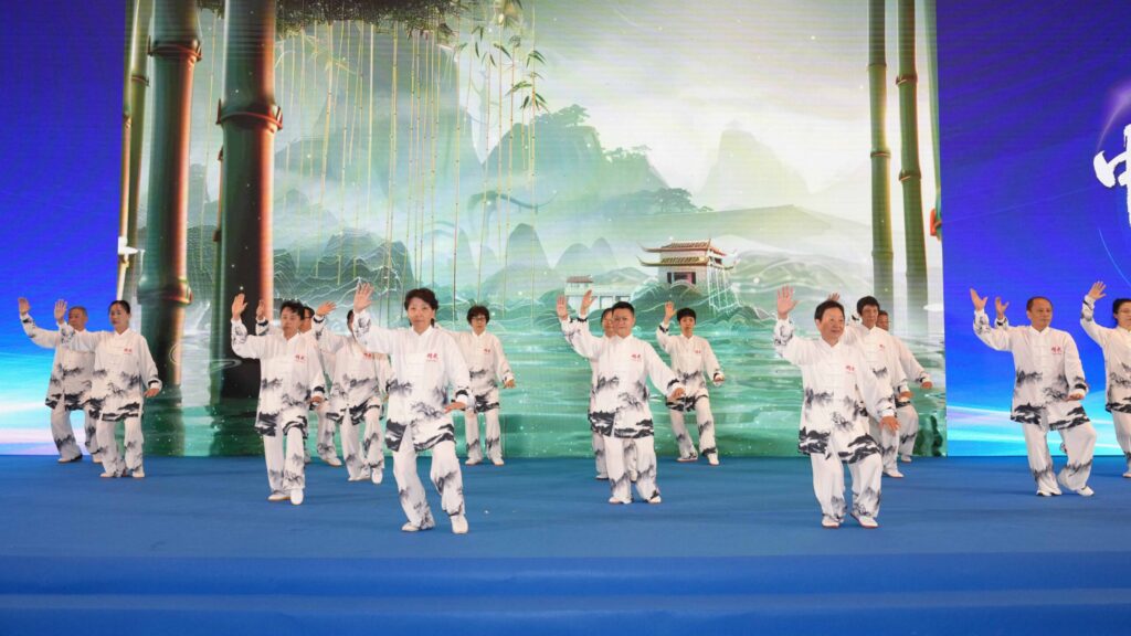 Tai Chi practitioners perform in white uniforms during the Sino-Thai cultural exchange programme.