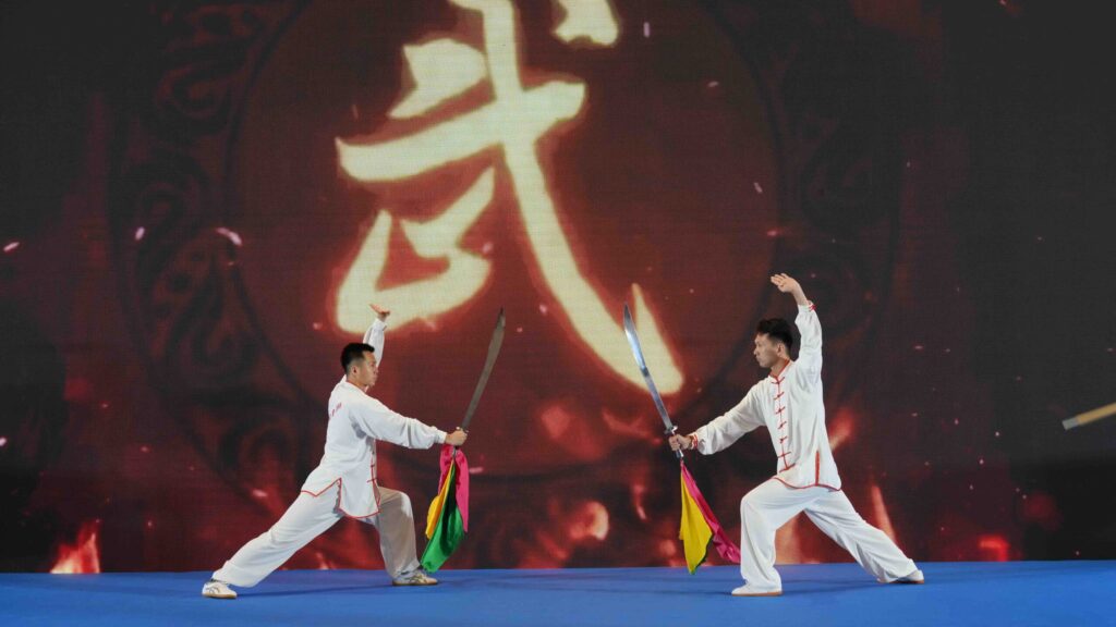 Martial arts performers present a traditional sword demonstration during the Tai Chi cultural exchange.