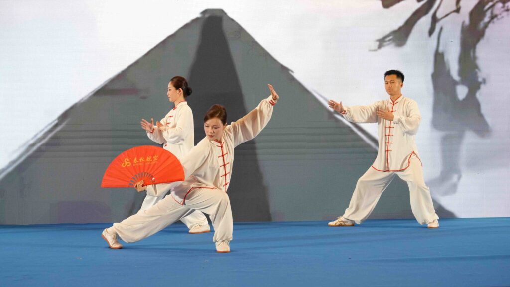Performers demonstrate Tai Chi fan movements as part of the China-Thailand cultural programme.