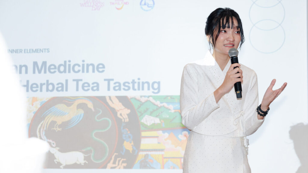 Thai wellness speaker presents traditional medicine and herbal tea tasting at Global Wellness Day 2026 in Bangkok.
