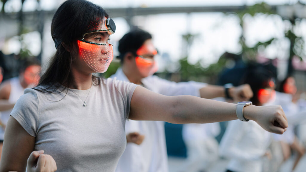 Participants join mindful movement with red light therapy masks during Global Wellness Day 2026 in Bangkok.