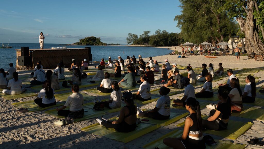 Participants join a beachfront wellness session in Ko Samui for Global Wellness Day 2026.