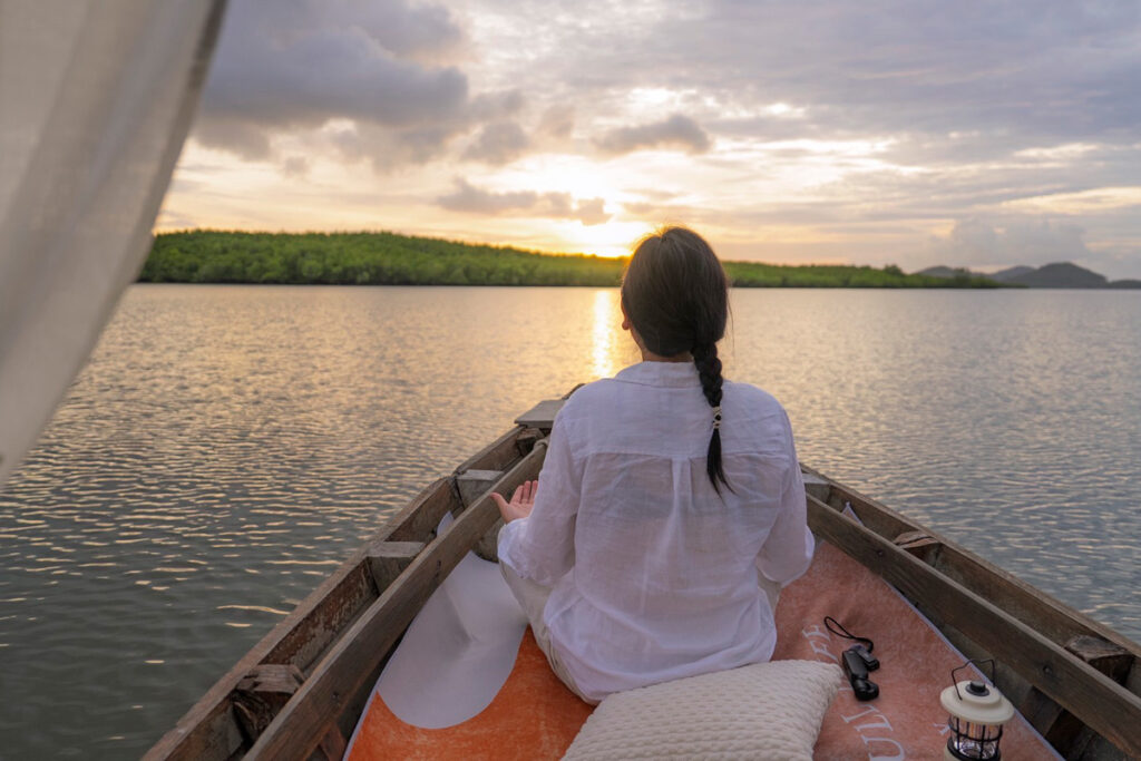 A participant joins a Sunrise Gondola Tour through Krabi’s mangrove landscape.