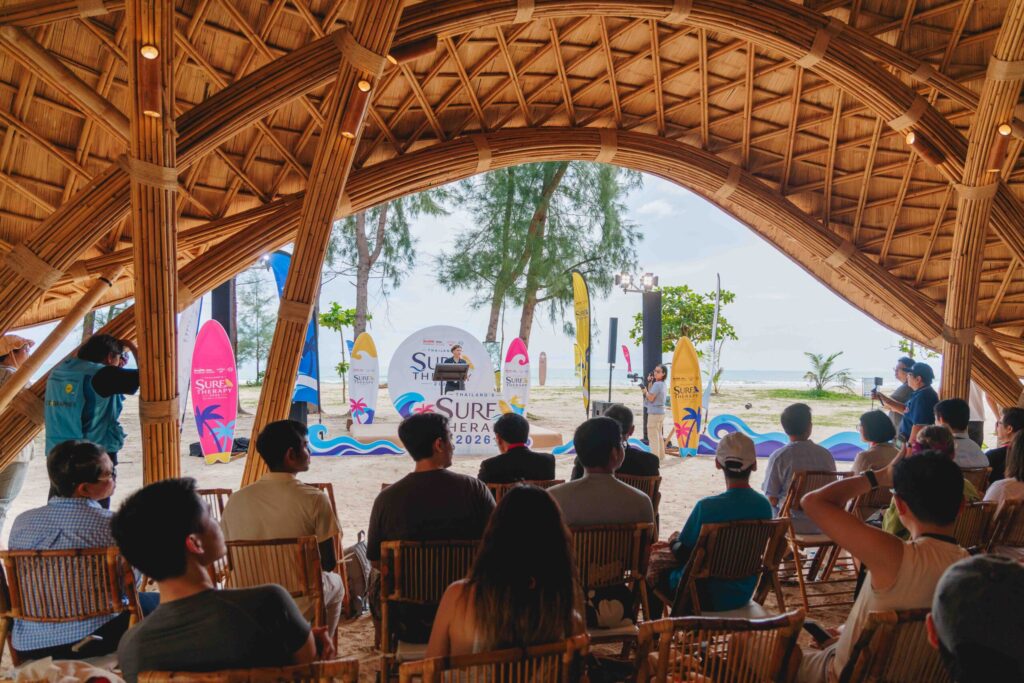 Participants join Thailand Surf Therapy 2026 presentation under a bamboo pavilion by the sea.