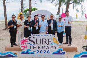 TAT officials and partners mark Thailand Surf Therapy 2026 on a beach in Phang-nga.