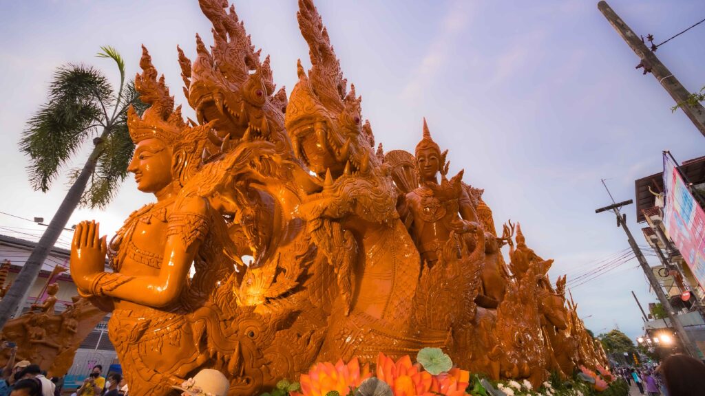 Intricately carved candle float depicting mythical figures at the Ubon Ratchathani Candle Procession.
