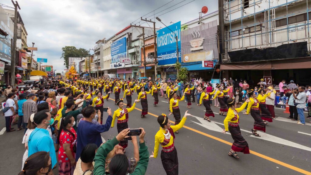Traditional dance troupe performs for spectators during the Ubon Ratchathani Candle Procession parade.