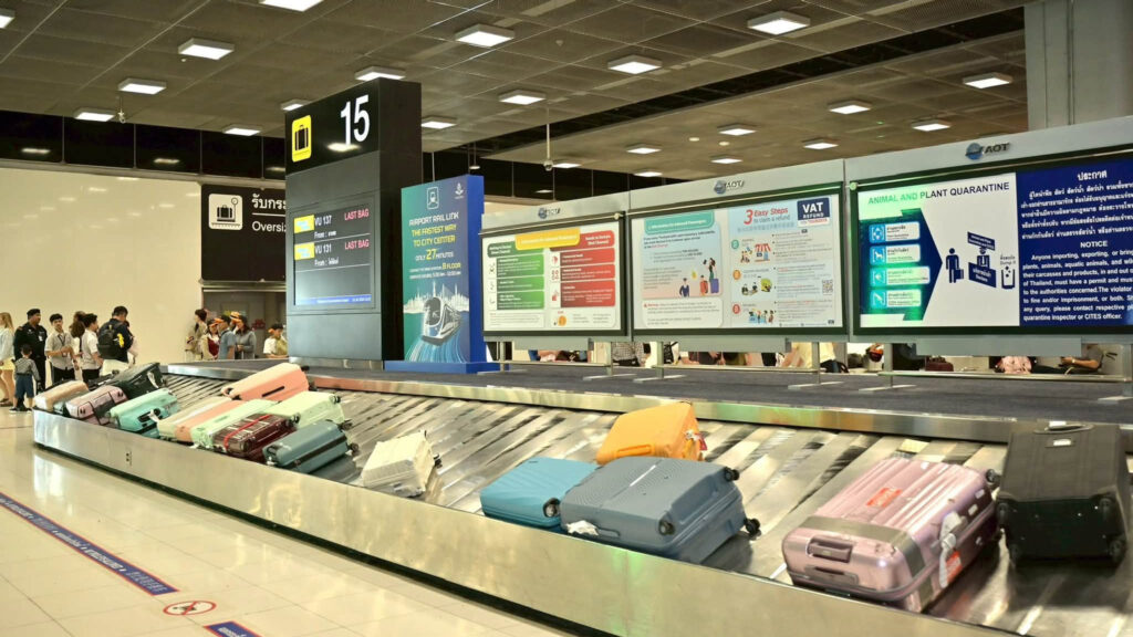 Passenger luggage moves through the baggage-claim area at Suvarnabhumi Airport.