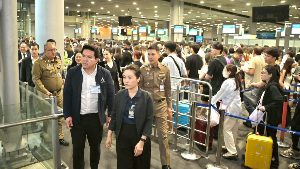 Officials review crowded passenger-processing areas and queue management measures at Suvarnabhumi Airport.