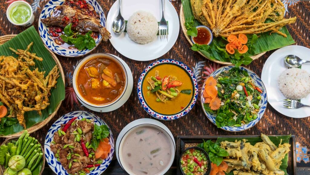 Southern Thai dishes with rice, curries, fried vegetables, and fresh herbs at Nai Muang Khao Lak Restaurant in Phang-nga.