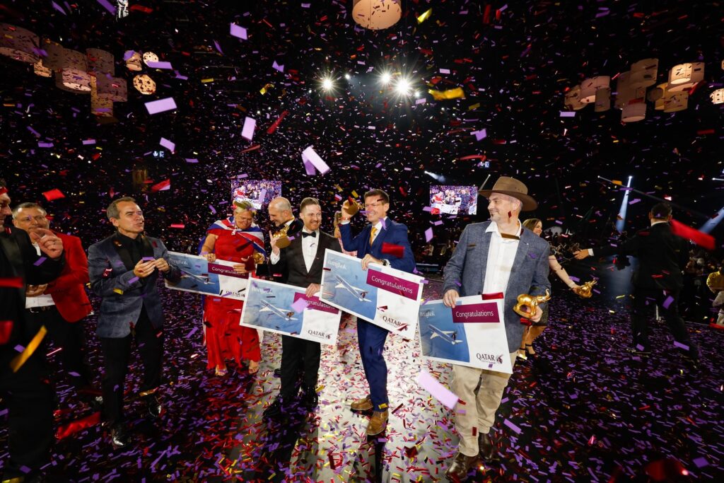 Award recipients celebrate on stage beneath colourful confetti at the Global Awards Dinner.