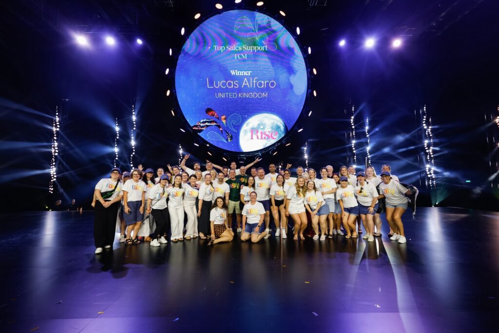 Flight Centre delegates gather for a group photo on the Bangkok conference stage.