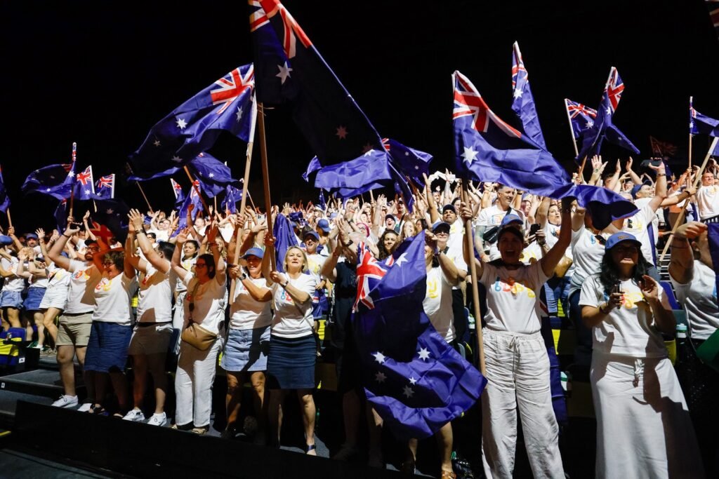 Flight Centre Global Gathering Bangkok 2026 delegates celebrate while waving Australian flags.