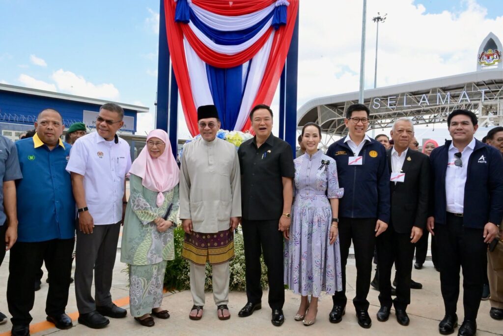 Thai and Malaysian officials gather at the opening of the new cross-border road connection.