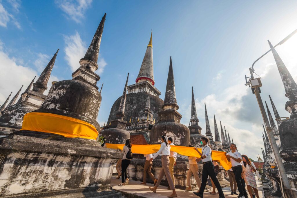 Worshippers carry a sacred saffron cloth around the Great Reliquary at Wat Phra Mahathat Woramahawihan.