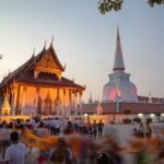 Visitors gather at Wat Phra Mahathat Woramahawihan in Nakhon Si Thammarat during an evening Buddhist ceremony.