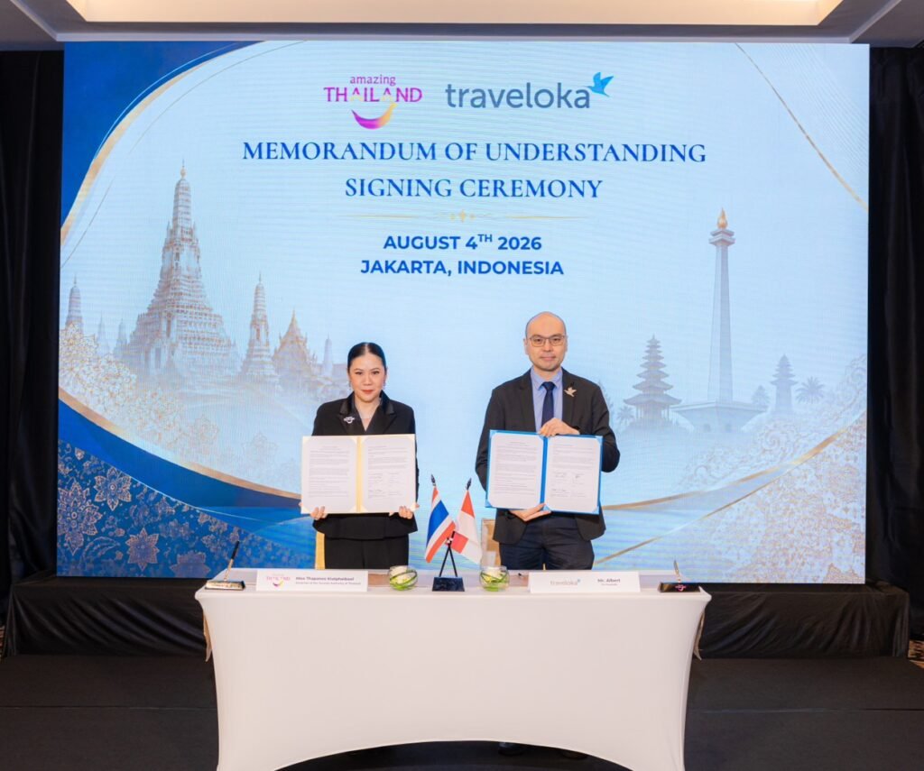 TAT Governor Thapanee Kiatphaibool and Traveloka co-founder Albert display their signed tourism partnership agreement.