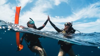 Scuba divers celebrate a successful dive in Thailand as part of TAT and PADI wellness-led dive tourism initiative
