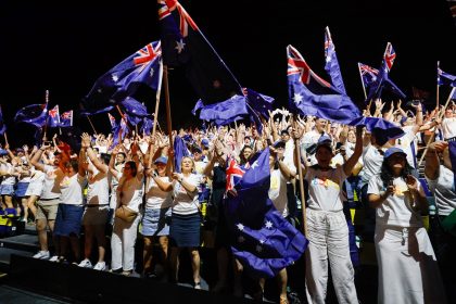 Flight Centre Global Gathering Bangkok 2026 delegates celebrate while waving Australian flags.