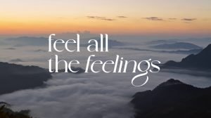 Campaign visual reading “feel all the feelings” over a sea of mist at dawn, representing the emotional travel journey presented by TAT and LISA.