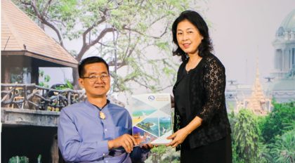 Mrs. Somrak Kumputch, TAT Deputy Governor for Administration, presents the Tourism for All guidebook to Mr, Krisana Lalai, President of Friendly Design for All Foundation, a human rights worker and a famous journalist and TV host in Thailand