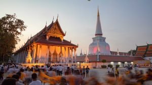 Visitors gather at Wat Phra Mahathat Woramahawihan in Nakhon Si Thammarat during an evening Buddhist ceremony.