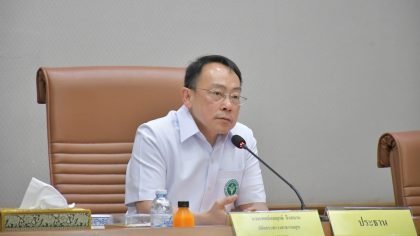 Ministry of Public Health official speaking into a microphone during a meeting on updated Ebola prevention measures in Thailand.